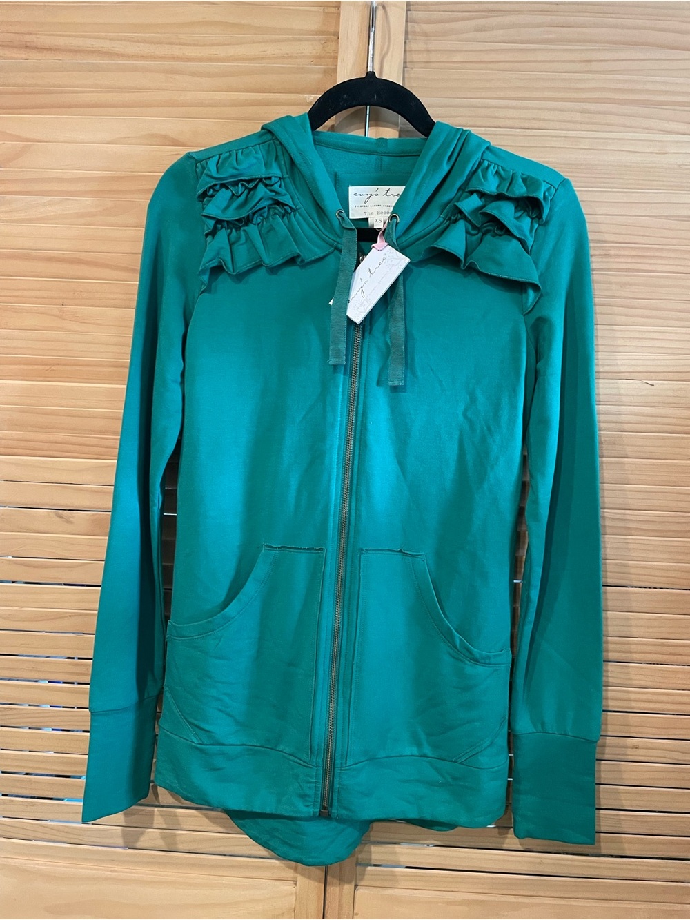 Evy’s Tree The Reece Women’s Green Zip-Up Hoodie with Ruffle Detail.